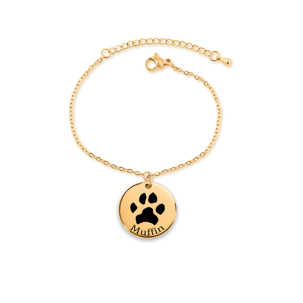 Pulsera dorada con colgante redondo y la huella de un perro grabada